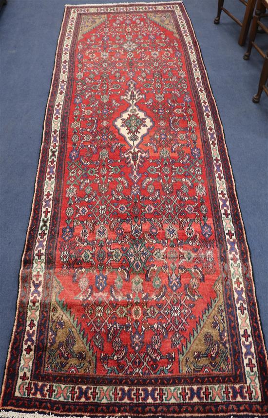A Hamadan red ground runner, 10ft 2in by 3ft 6in.